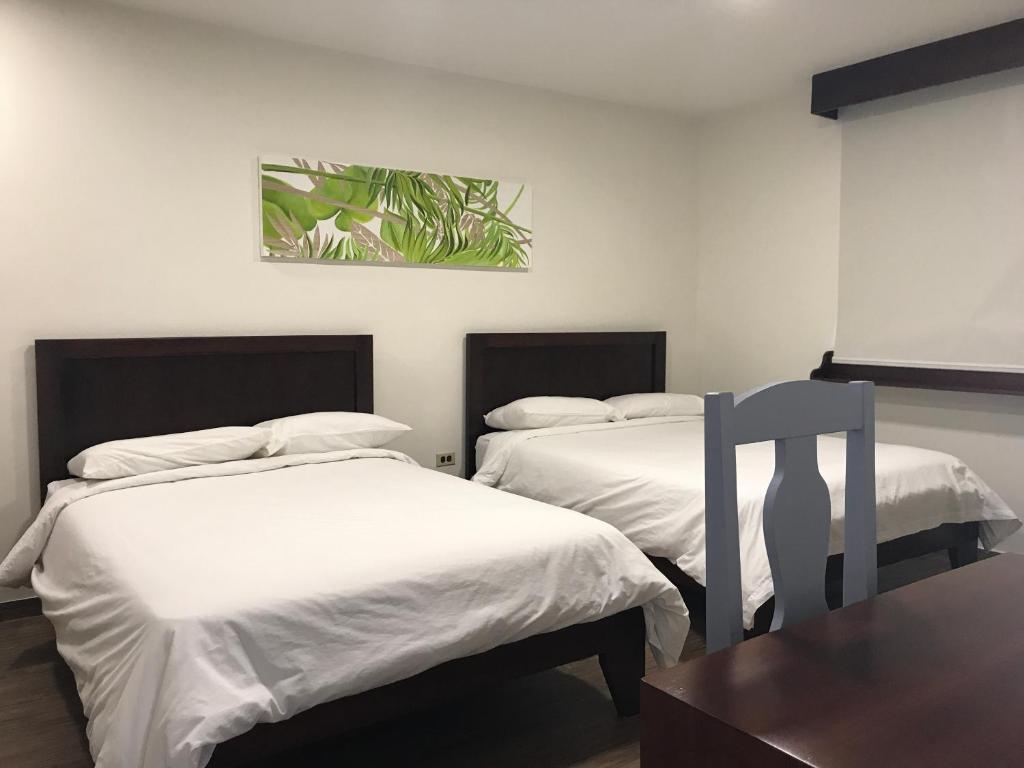 Postel nebo postele na pokoji v ubytování Hotel Plaza