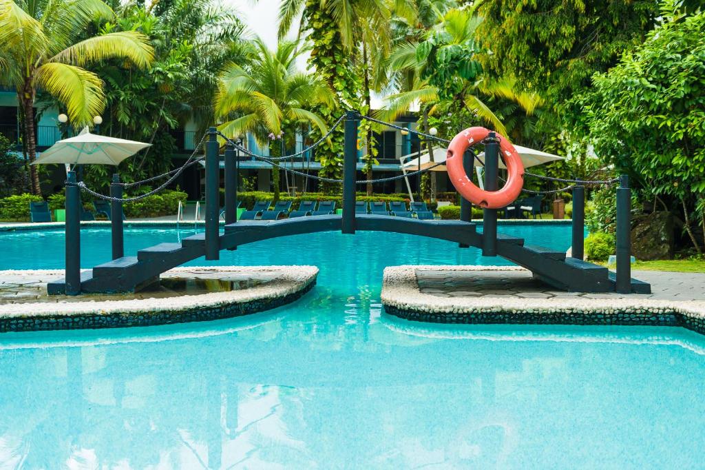 a swimming pool with a slide in a resort at Riande Aeropuerto Hotel Casino in Tocumen