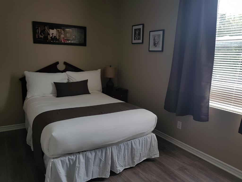 1 dormitorio con 1 cama con sábanas blancas y negras en Cozy 1-Bedroom Suite #17 by Amazing Property Rentals, en Gatineau