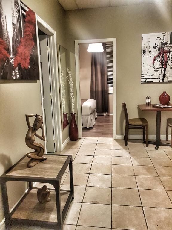 a room with a statue of a monkey sitting on a table at Cozy 1-Bedroom Suite #17 by Amazing Property Rentals in Gatineau