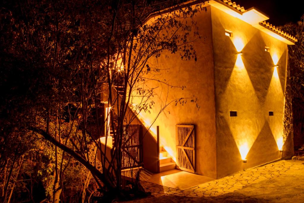 a building with lights on the side of it at night at Casa Mono in San Agustinillo