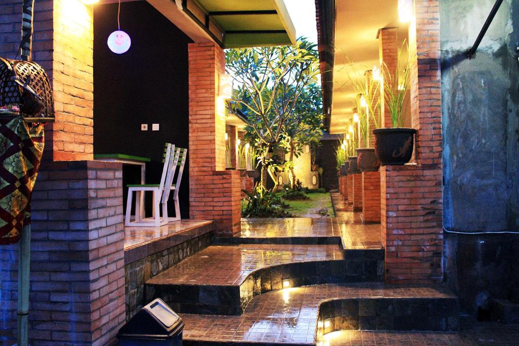 a house with a water feature on the side of it at Ulu Bali Homestay in Jimbaran