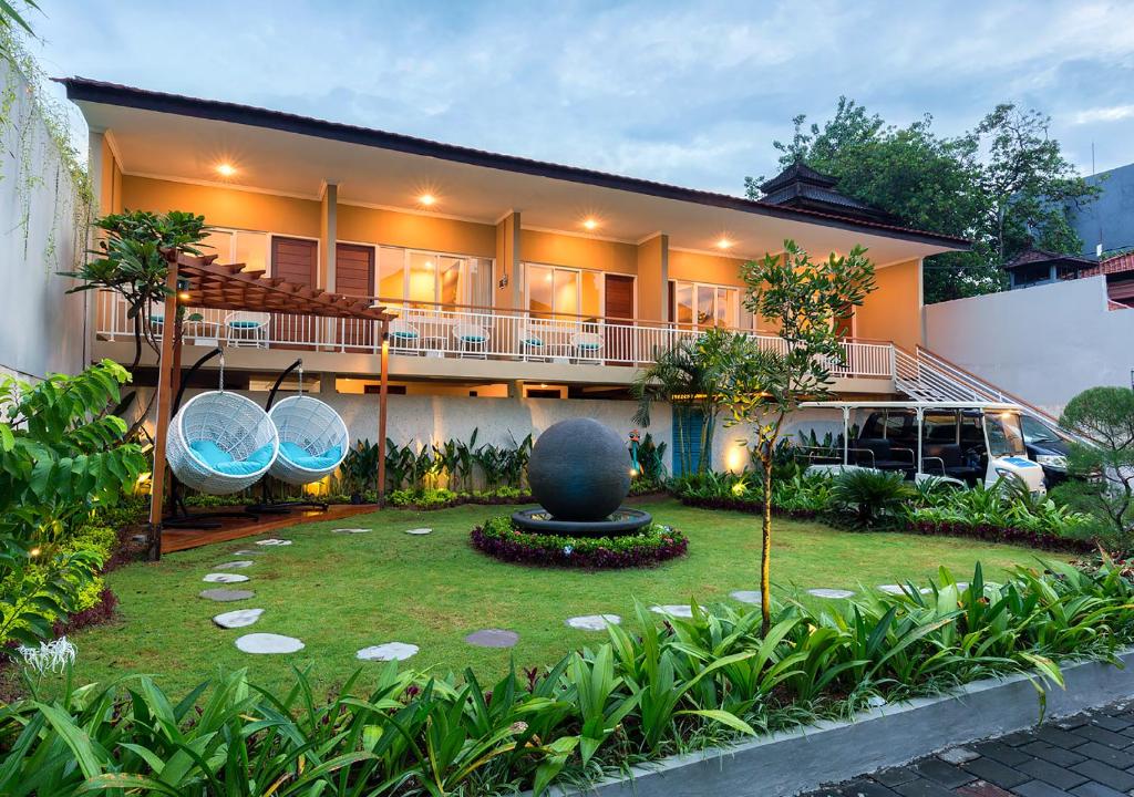 a house with a garden in front of it at Destiny Villas and Residence in Seminyak