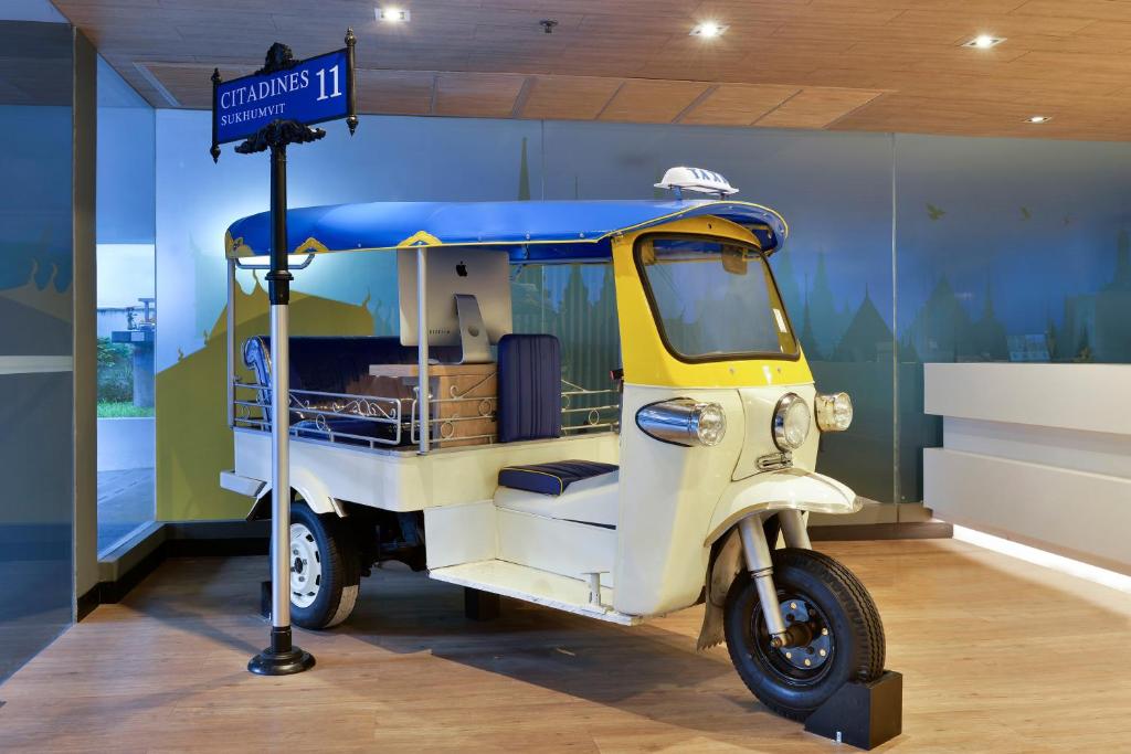 a small food cart with a sign in a room at Citadines Sukhumvit 11 Bangkok in Bangkok