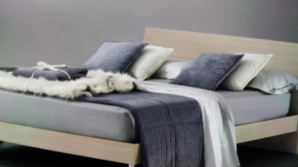 Łóżko lub łóżka w pokoju w obiekcie Alessi Suites & Studio