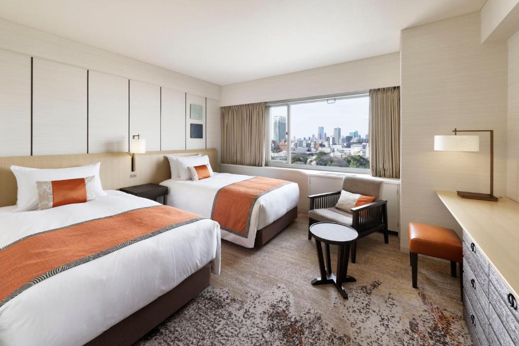 a hotel room with two beds and a window at Grand Prince Hotel Takanawa in Tokyo