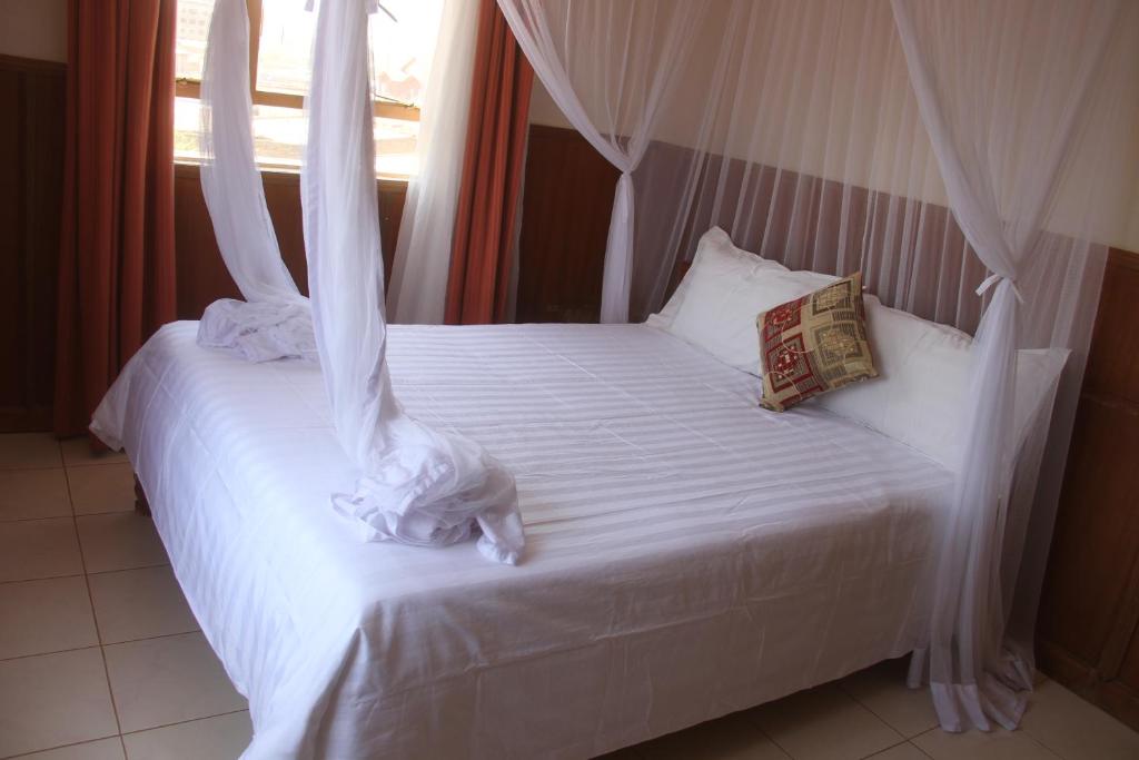 Postel nebo postele na pokoji v ubytování Bomen Hotel