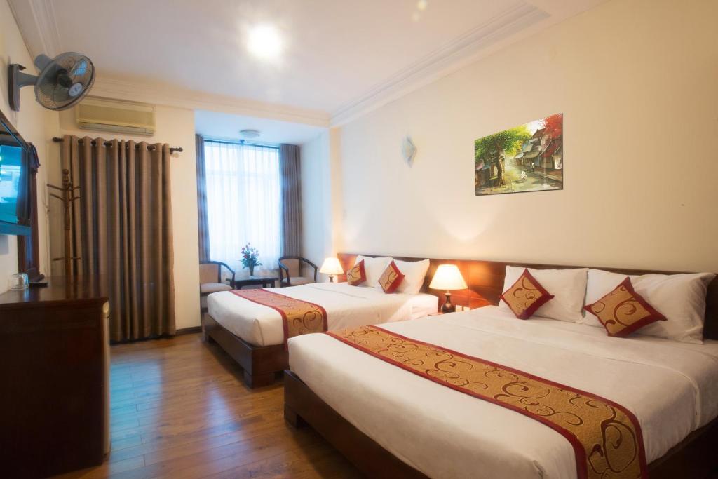 Postel nebo postele na pokoji v ubytování Ngoc Minh Hotel