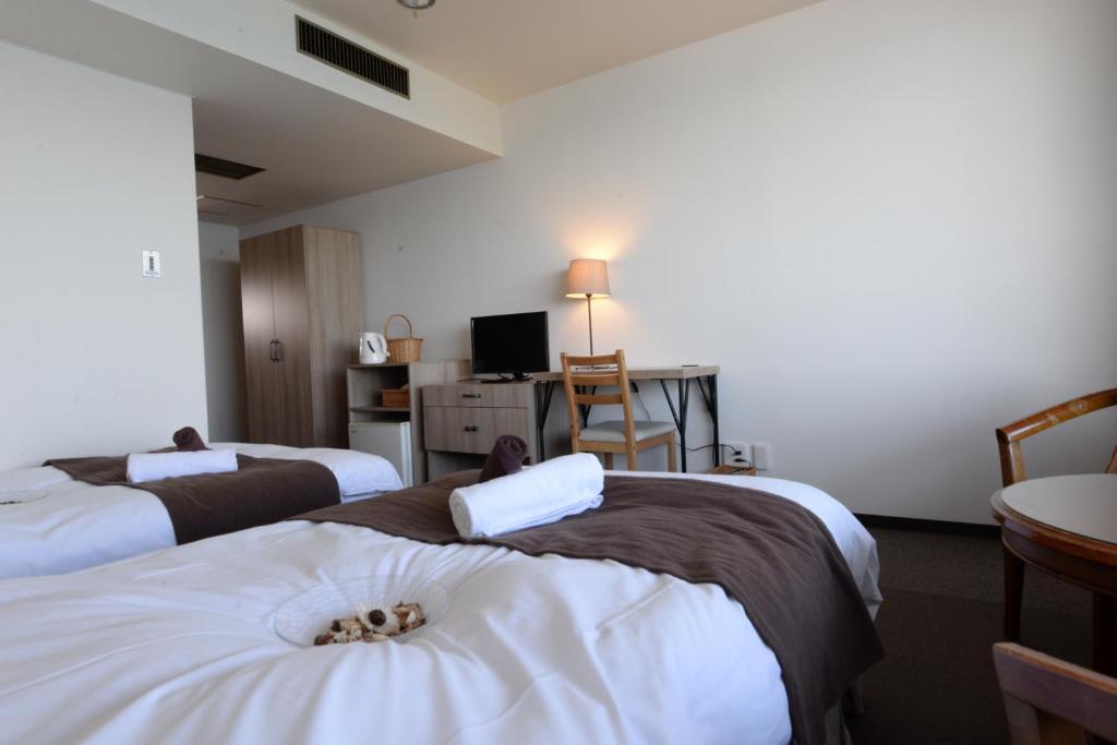 Postel nebo postele na pokoji v ubytování Isohara Seaside Hotel