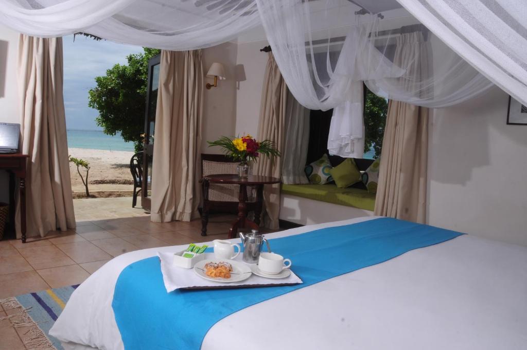 A bed or beds in a room at Jacaranda Indian Ocean Beach Resort