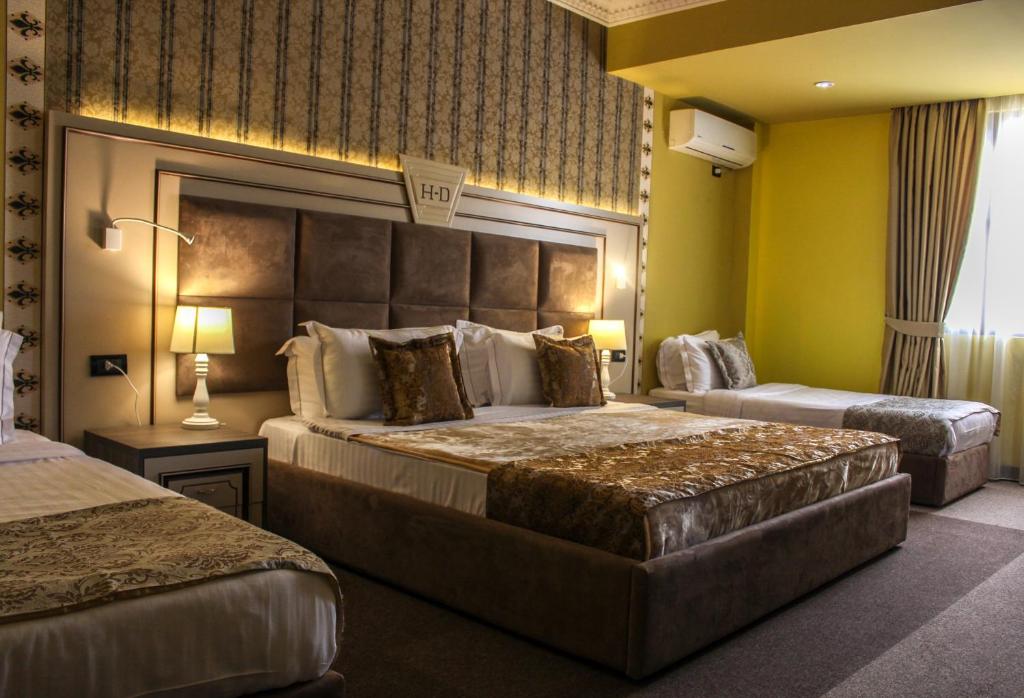 Postel nebo postele na pokoji v ubytování Hotel Deluxe