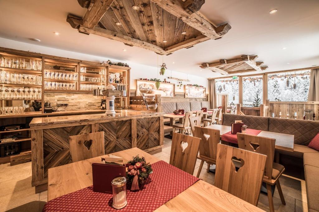 a restaurant with wooden walls and tables and chairs at LandererMühle in Lenggries