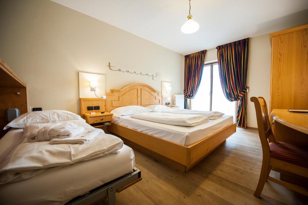 Postel nebo postele na pokoji v ubytování Hotel Touring