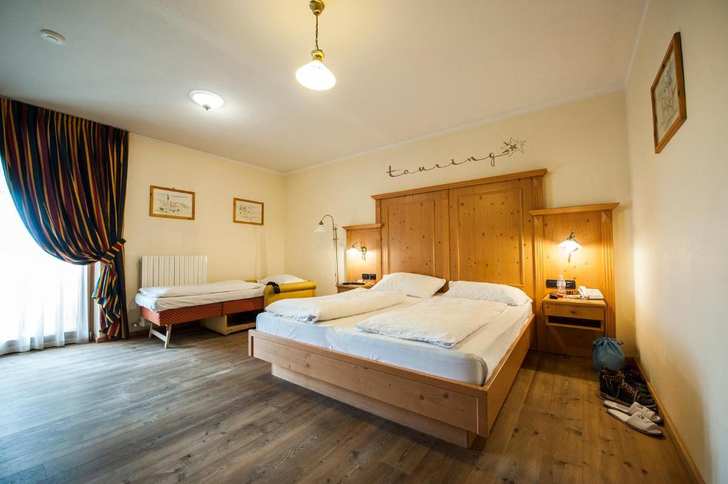 Postel nebo postele na pokoji v ubytování Hotel Touring