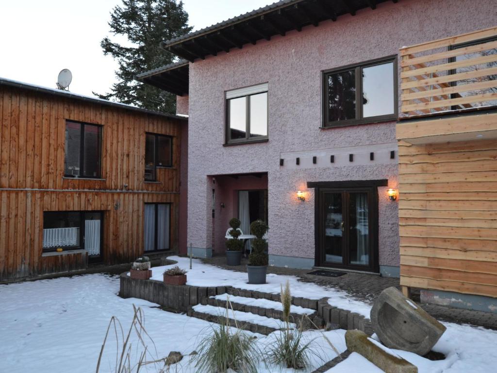 a house with a courtyard in the snow at Apartment Manderscheid near Castle Ruins in Manderscheid