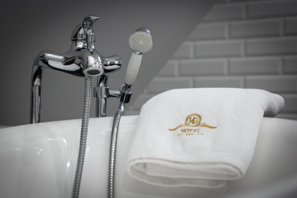 Koupelna v ubytování HG Hotel