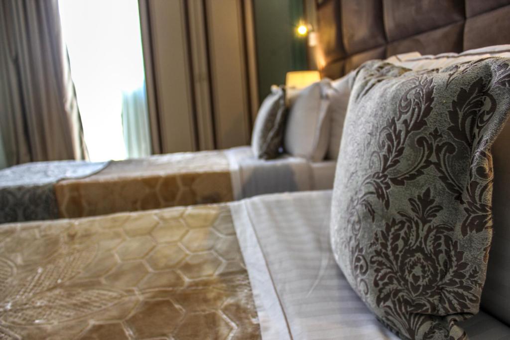 Postel nebo postele na pokoji v ubytování Hotel Deluxe