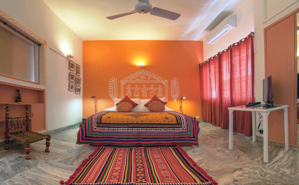 a bedroom with a bed and a television in it at Haveli Hauz Khas in New Delhi