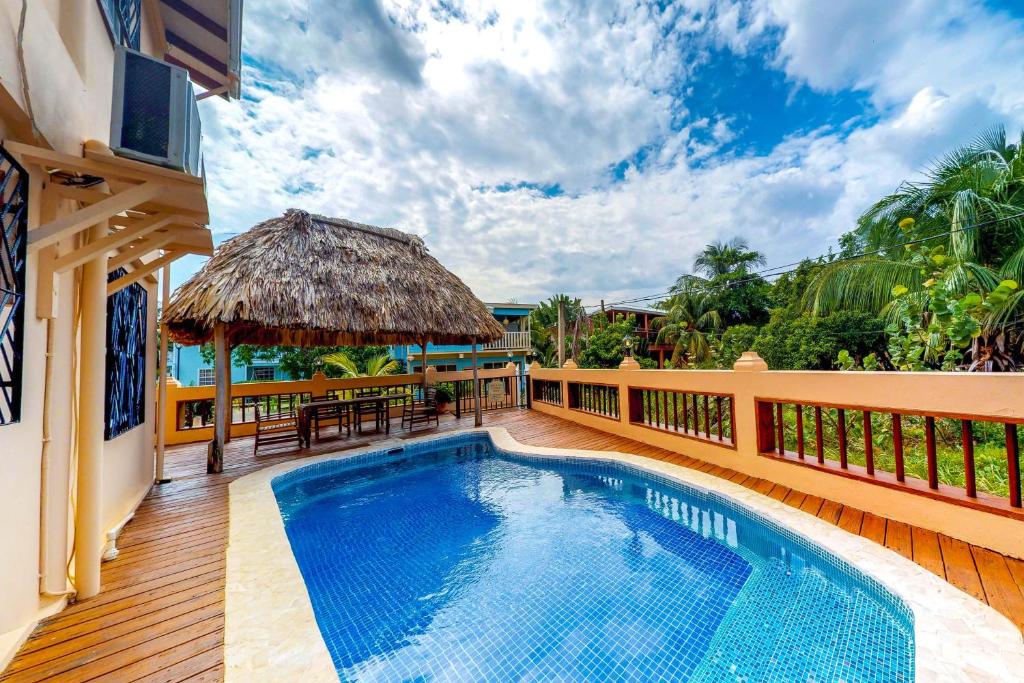 a villa with a swimming pool and a deck at Mirasol Villa in Placencia