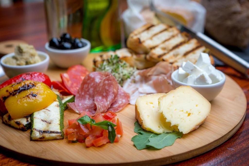 a plate of food with meats and vegetables on a table at Maldron Hotel Kevin Street, Dublin City in Dublin