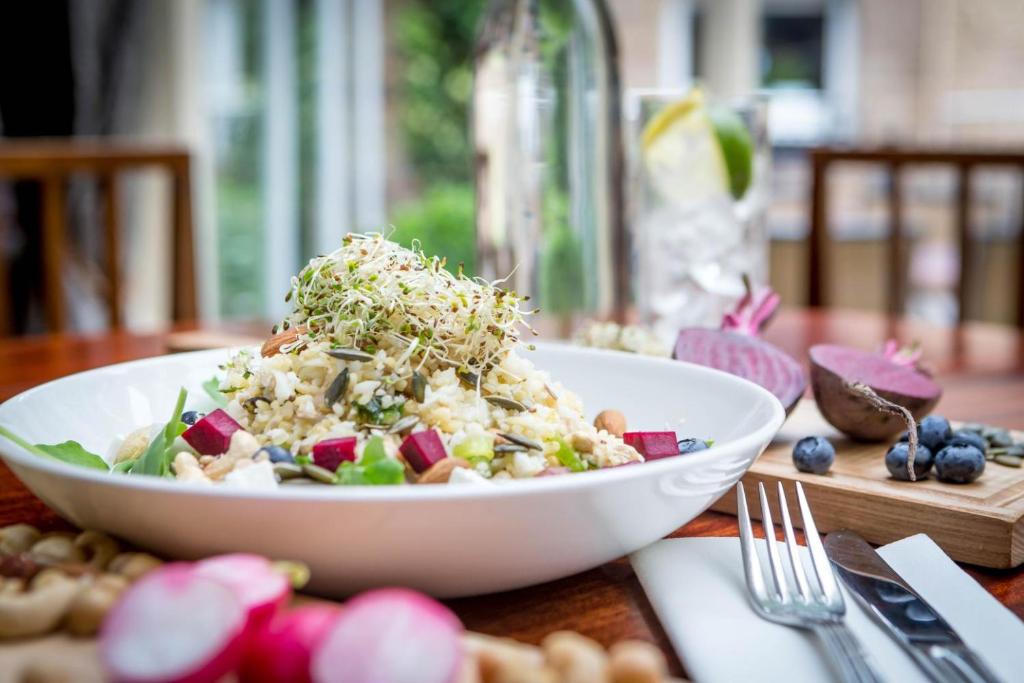 a white bowl of salad on a table at Maldron Hotel Kevin Street, Dublin City in Dublin