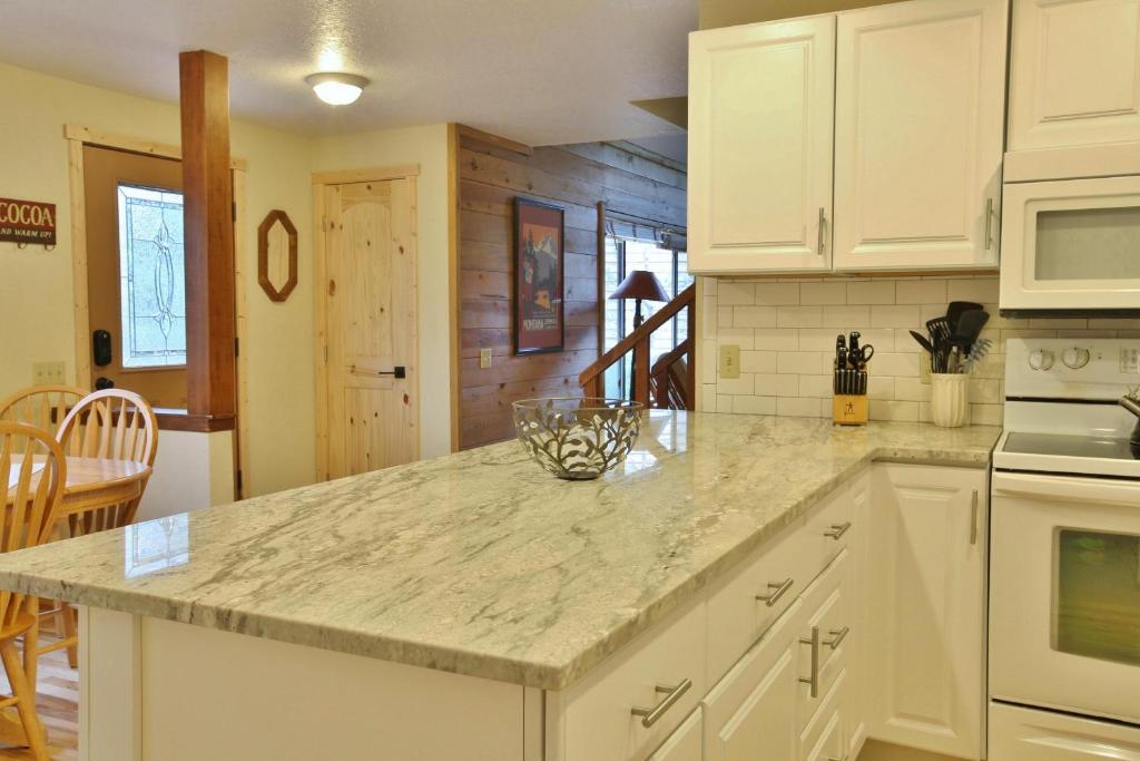 a kitchen with white cabinets and a counter top at 8 Leisure in Sunriver
