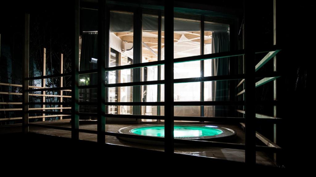 a view of a swimming pool through a window at Ecosuite & SPA in Milan