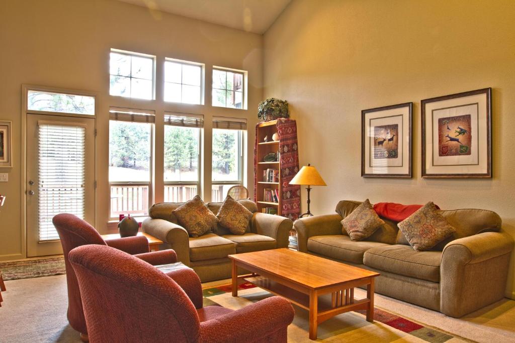 a living room with couches and tables and windows at Widgi Creek #22 in Deschutes River Woods