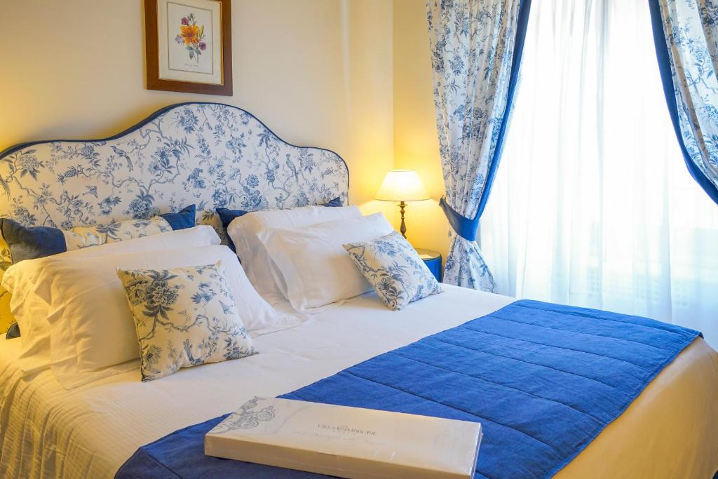 a bedroom with a bed with a book on it at Hotel Villa Cimbrone in Ravello