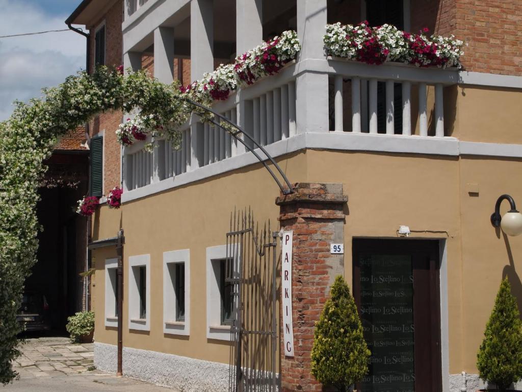 un edificio con un balcón con flores. en Soggiorno Lo Stellino, en Siena