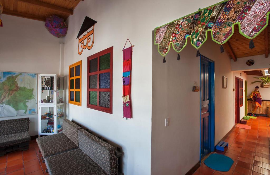 a living room with two chairs and flags on the wall at Casa Hospedaje La Bohemia in Pasto