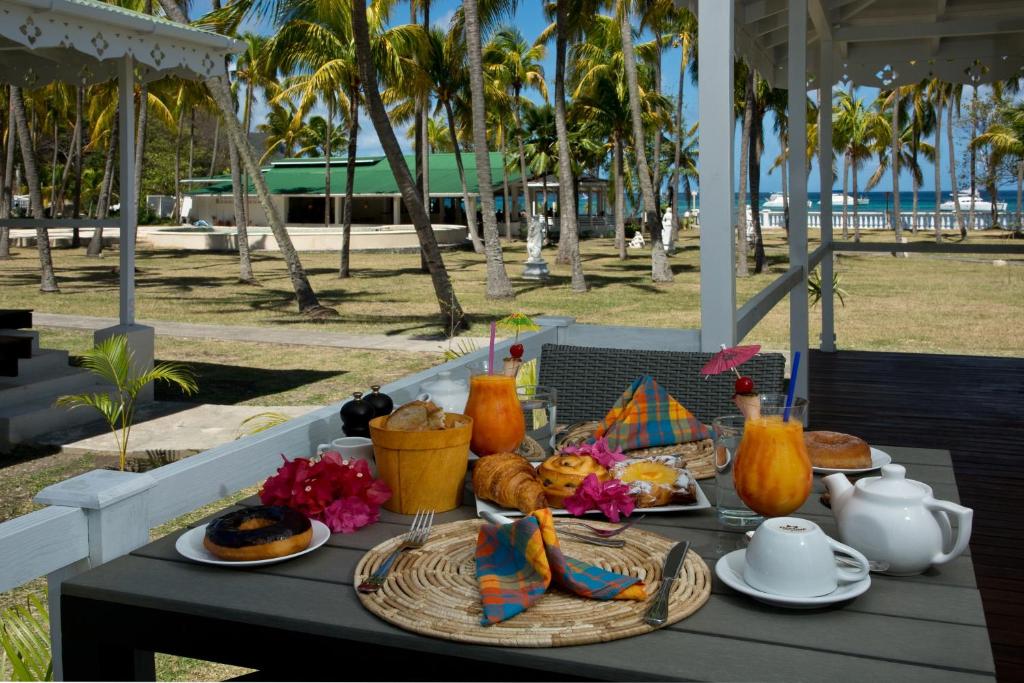 a table with food and drinks on top of it at Bequia Plantation Hotel in Bequia