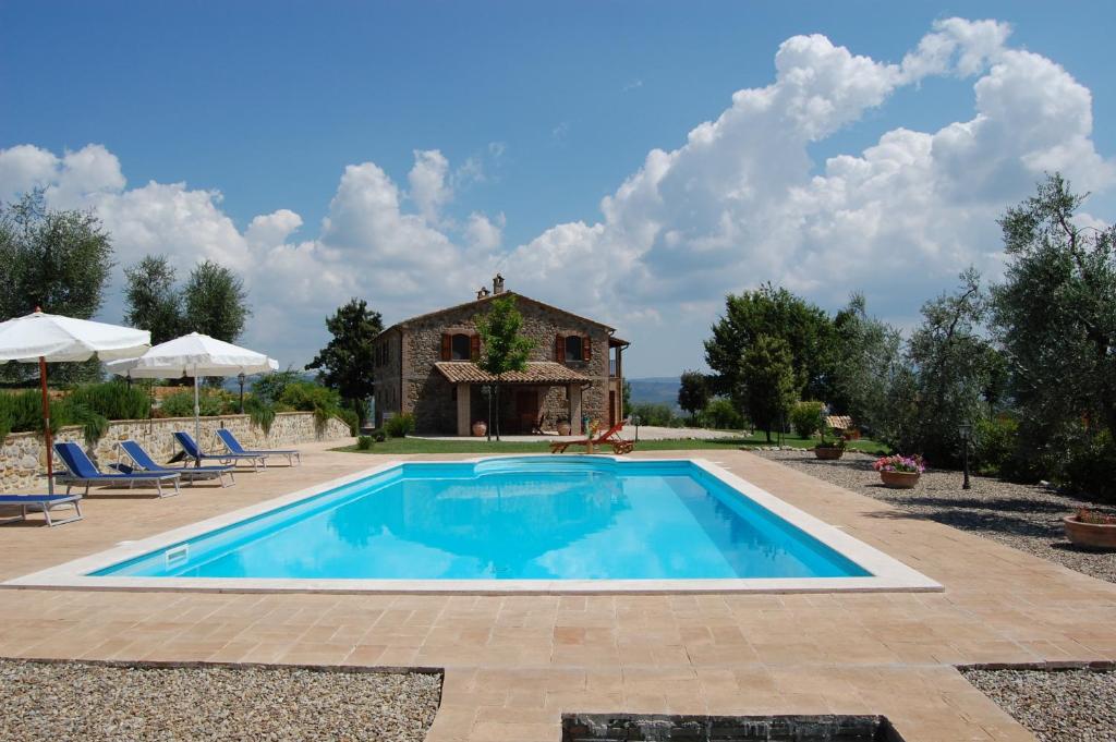 a swimming pool in front of a house at Villa Solaria in Orvieto