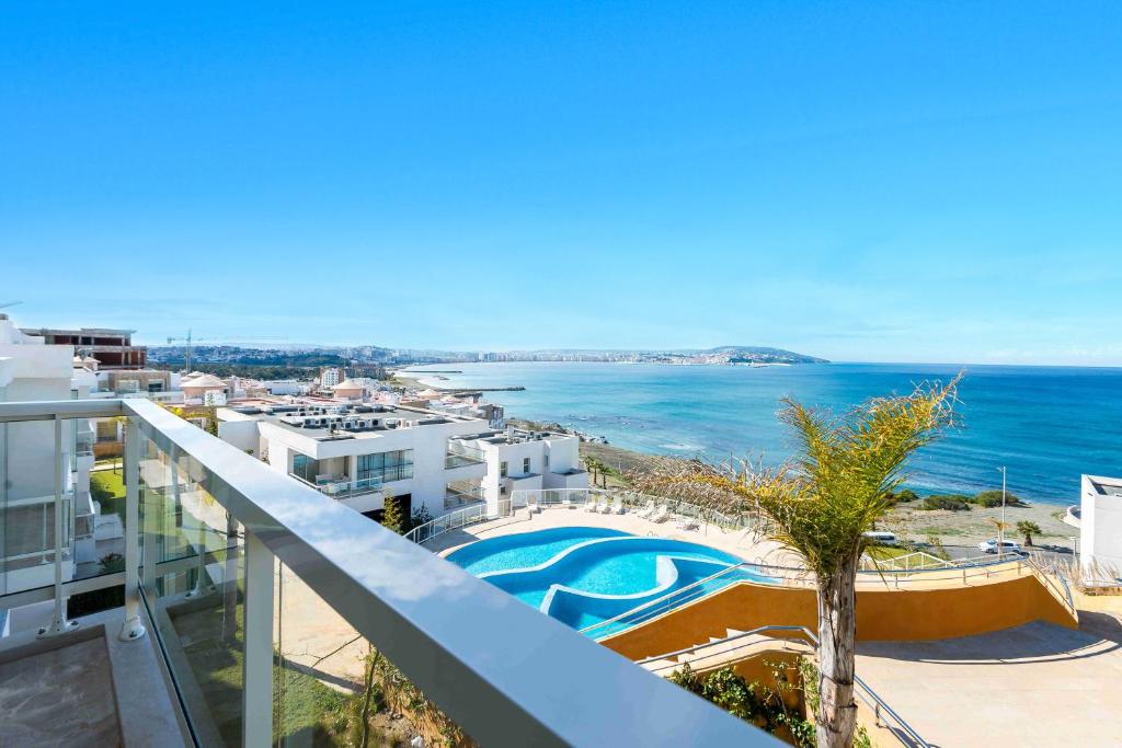 a view of the ocean from the balcony of a building at Hotel Farah Tanger in Tangier
