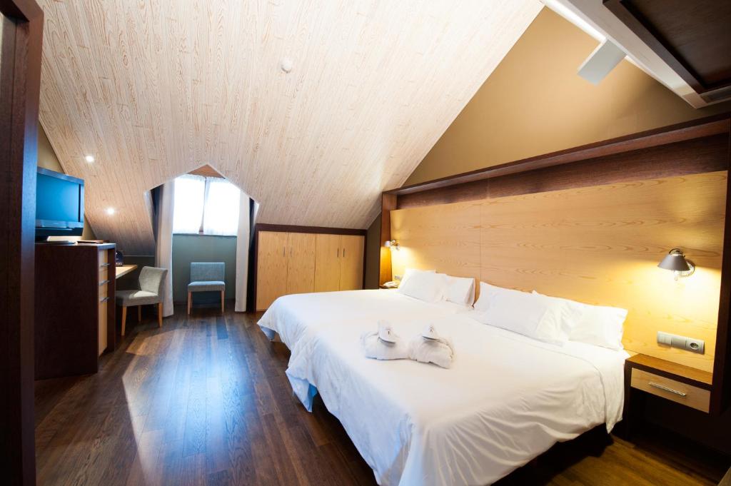 Postel nebo postele na pokoji v ubytování SOMMOS Hotel Aneto