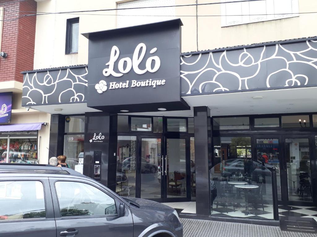 
a store front with a car parked in front of it at Lolo Hotel Boutique in Mar del Plata

