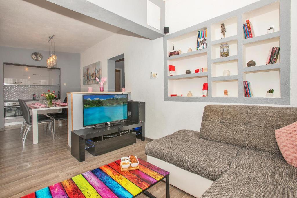 a living room with a couch and a tv at Apartman Koko with private jacuzzi in Makarska