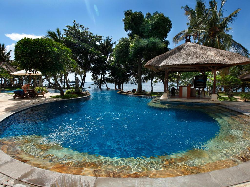 uma grande piscina com um gazebo num resort em Puri Bagus Lovina em Lovina