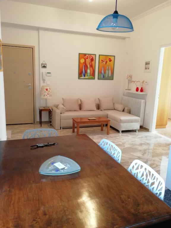 a living room with a table and a couch at Asimelia Luxury Apartment in Heraklio