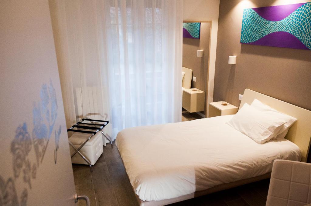 Postel nebo postele na pokoji v ubytování VILLA FENIX OSIO SOTTO