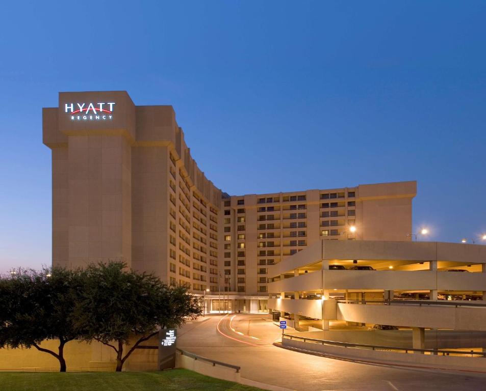 a hotel building with a sign on it at night at Hyatt Regency DFW International Airport in Dallas