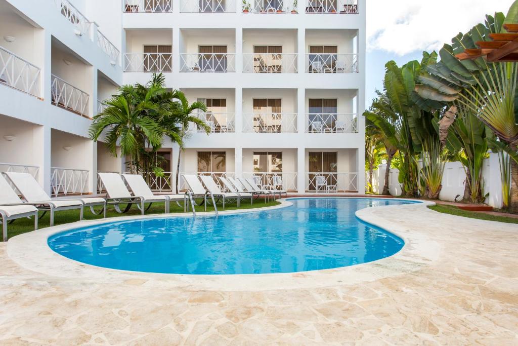 a large swimming pool in front of a large building at Apartamentos Punta Cana by Be Live in Punta Cana