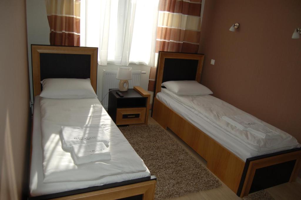 Posteľ alebo postele v izbe v ubytovaní Apartamenty Plaza Słupca