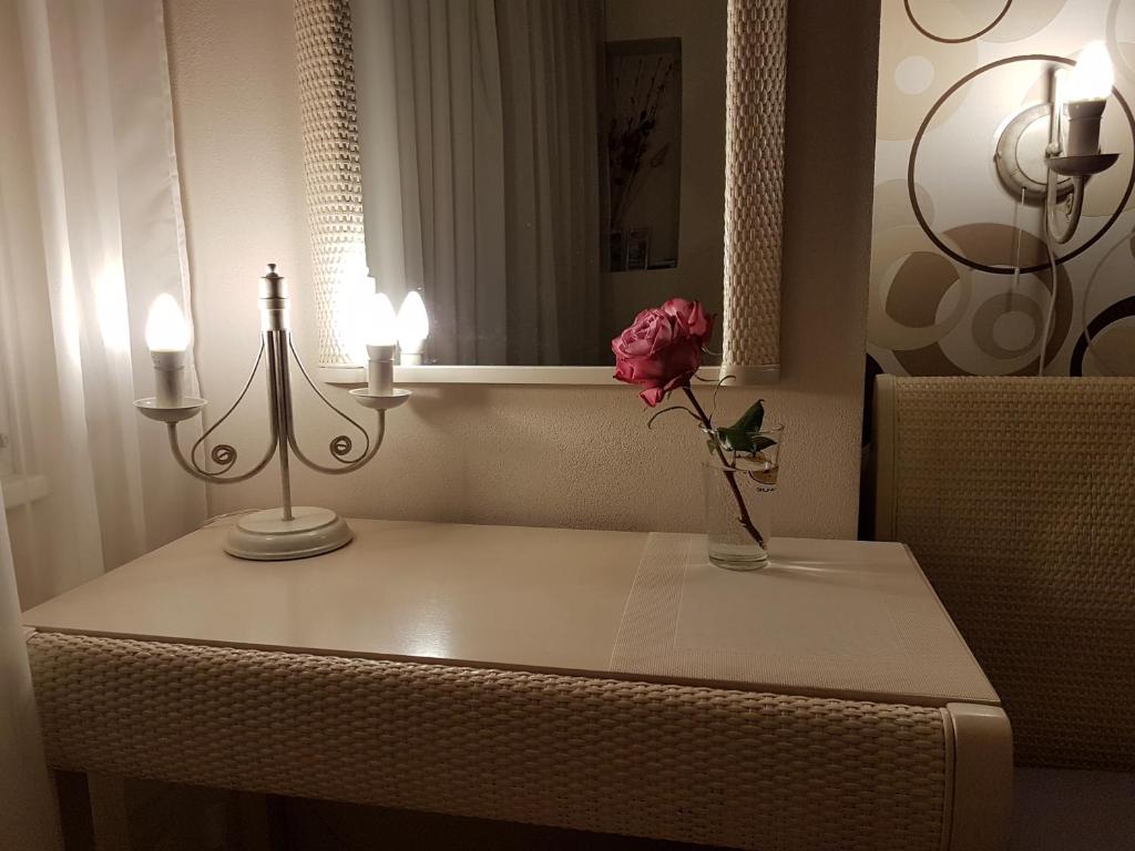 a table with a flower in a vase on it at Veles Apartment in Prague