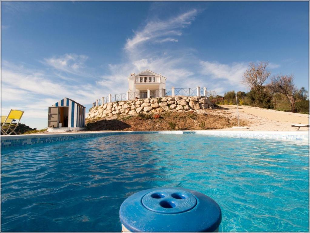 a swimming pool with a house in the background at Villa con Arte Jacuzzi By Mila Prieto in Algar