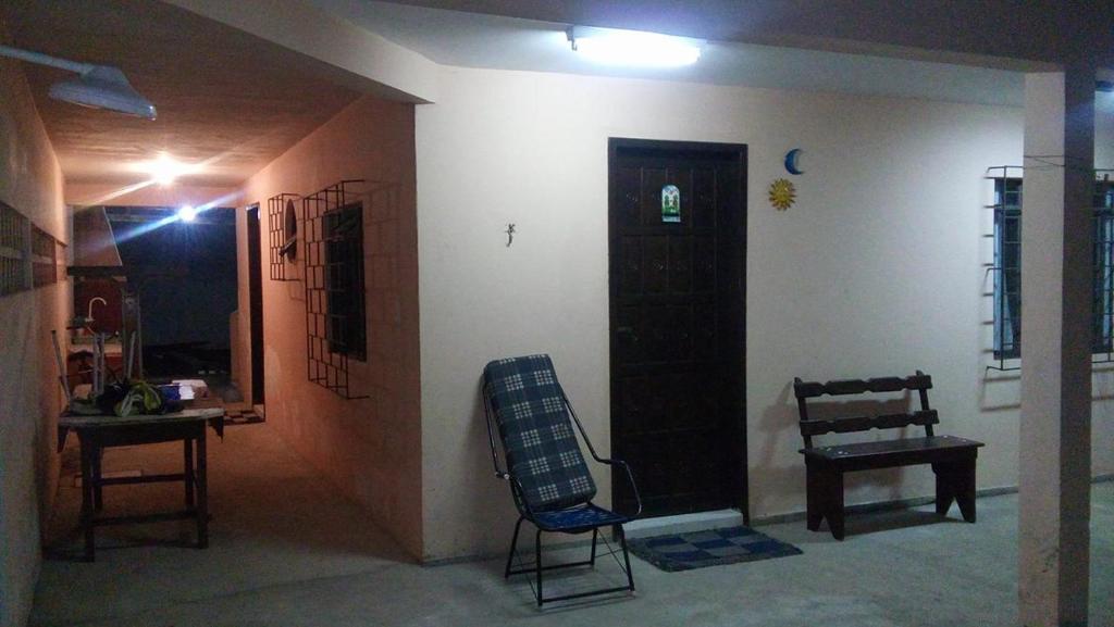 sala de estar con silla y puerta en Solar Dona Irma, en Guaratuba