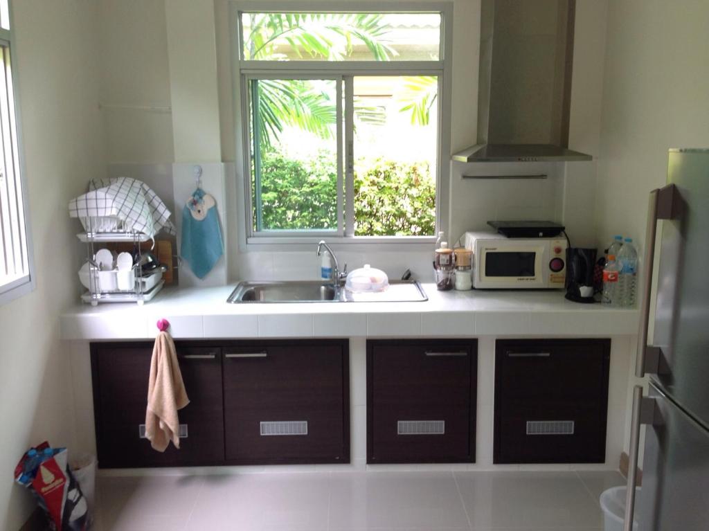 a kitchen with a sink and a window at Casa Seaside Rayong by Chate in Rayong