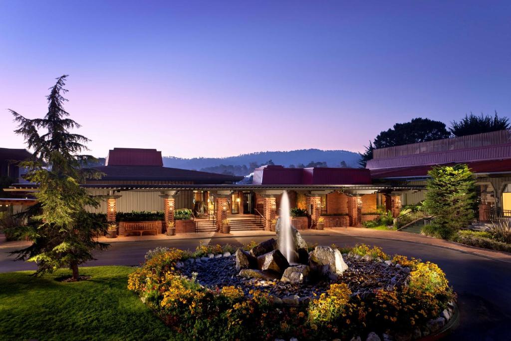 a building with a fountain in the middle of a yard at Hyatt Regency Monterey Hotel and Spa in Monterey