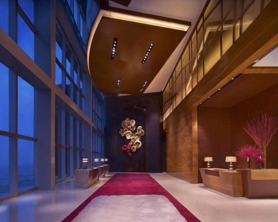 a hallway in a building with a chandelier at Grand Hyatt Shenzhen in Shenzhen