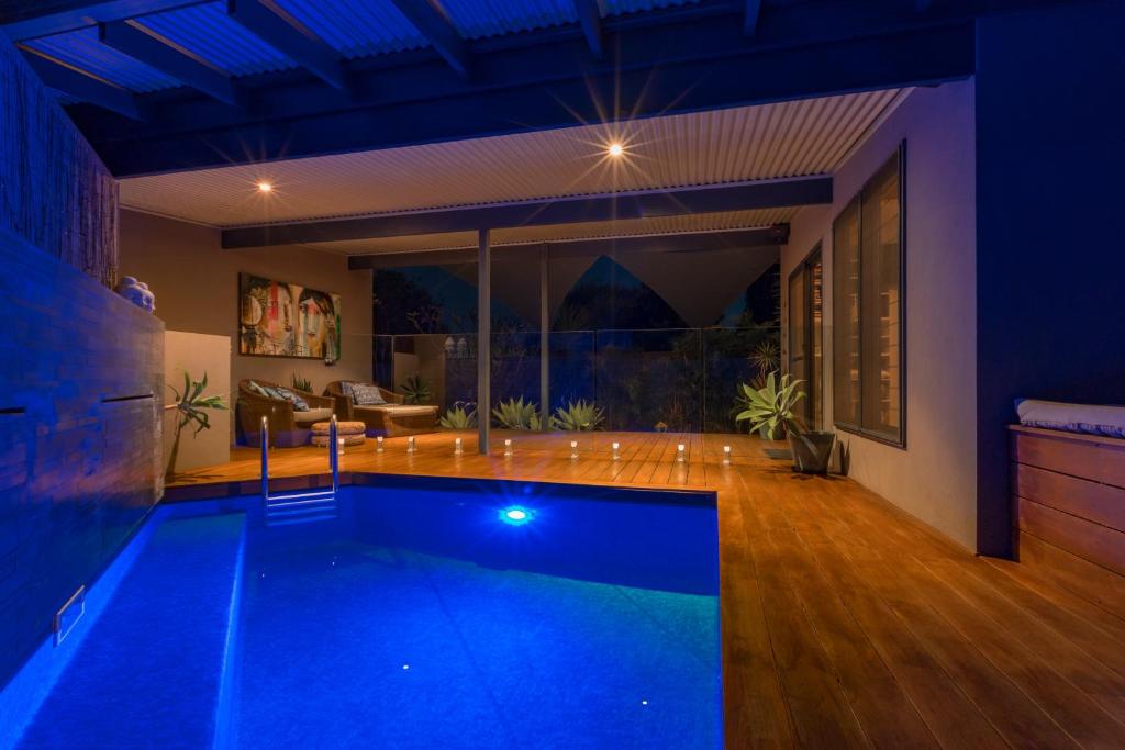a swimming pool in the middle of a house at night at Salt The Studio in Kalbarri